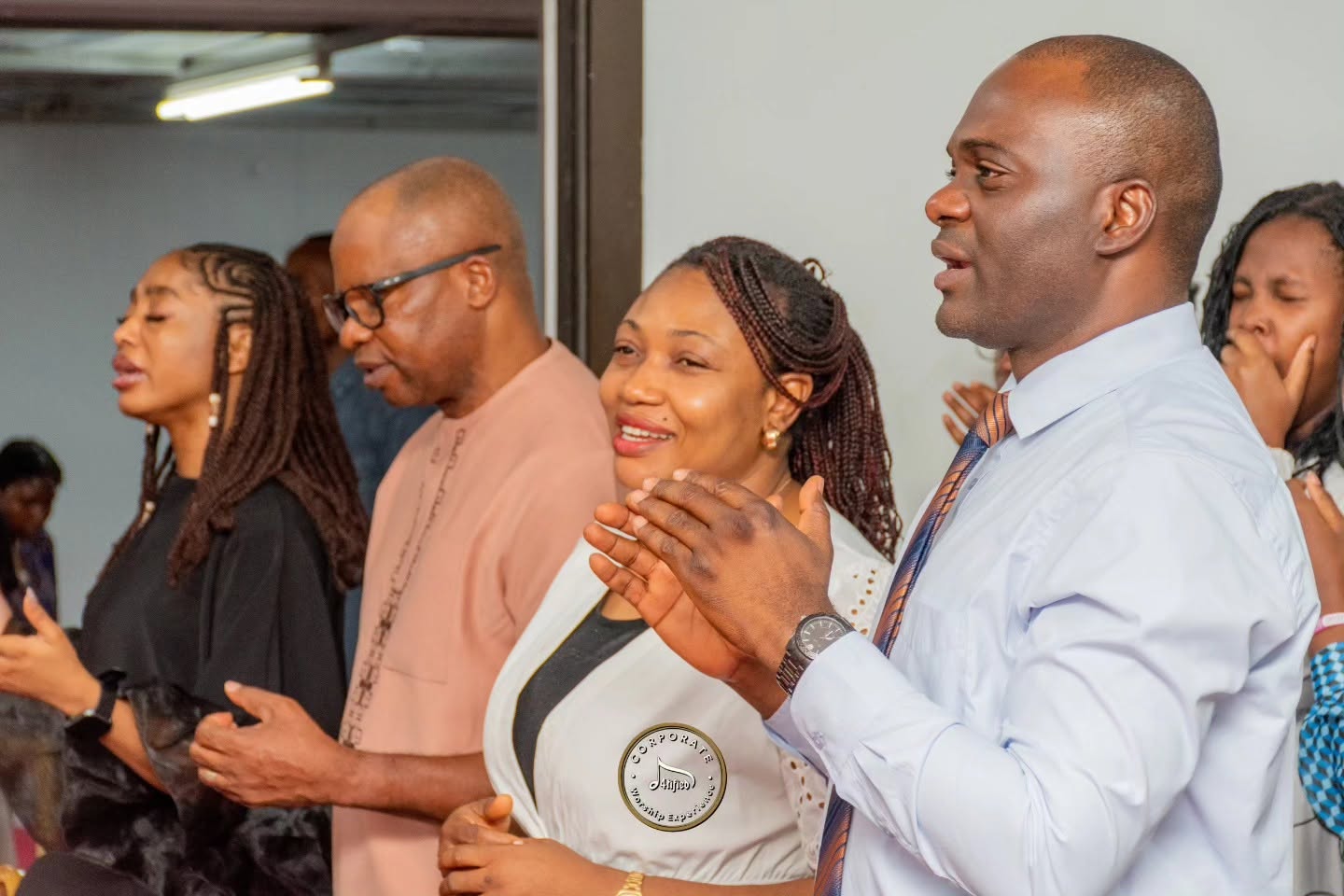 Members standing in praise during worship